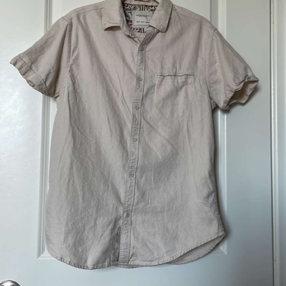 100% cotton cream colored button down t-shirt